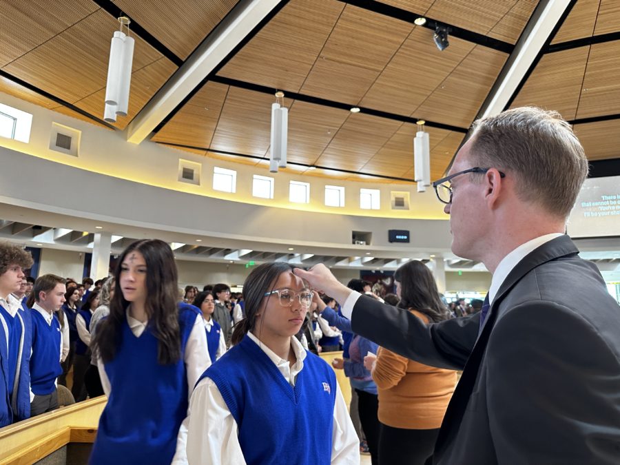 Bishop Gorman students receive ashes from Mr. Sinclair.