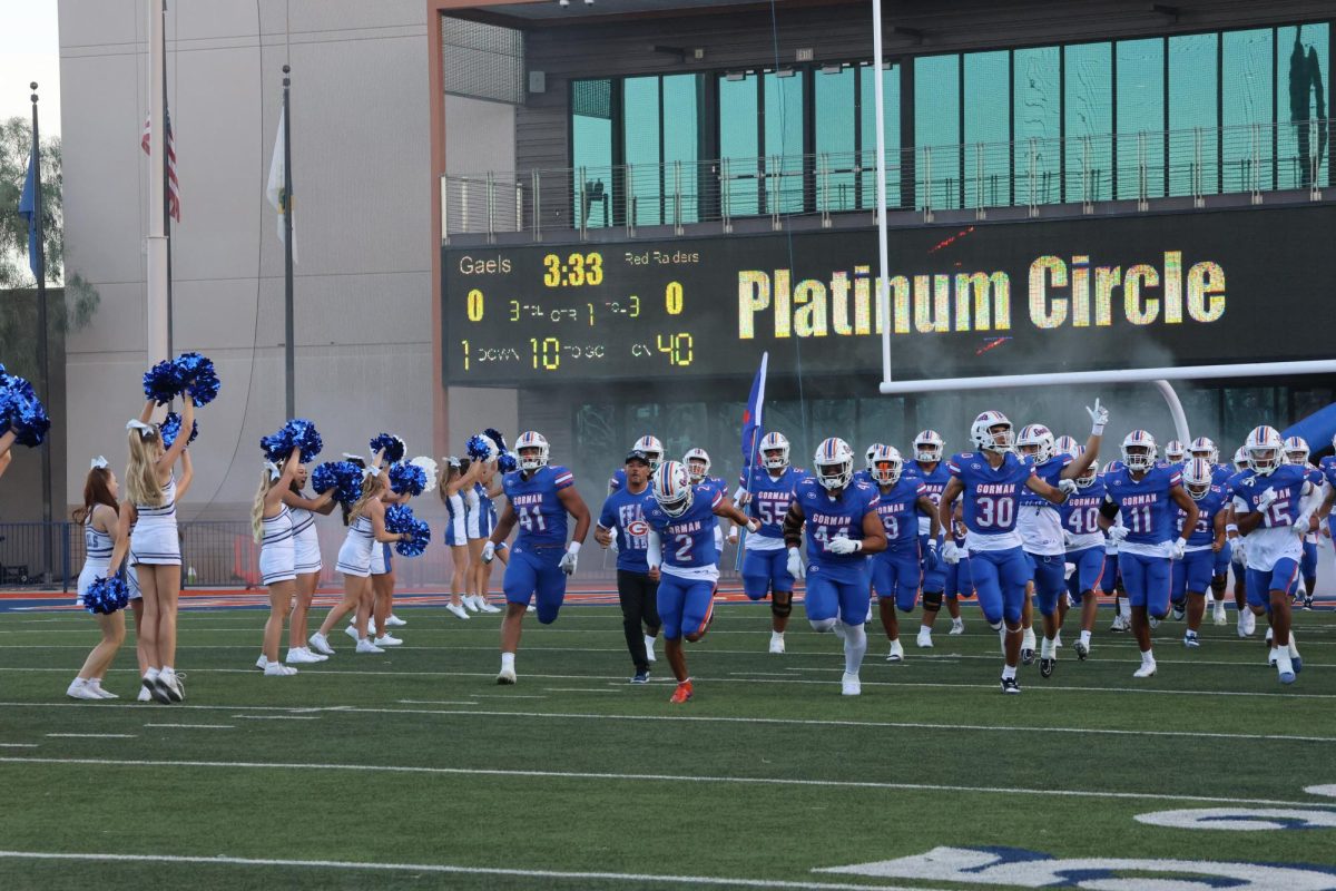 Bishop Gorman Gaels Varsity Football Team run onto the field at the start of their first game of the season. 