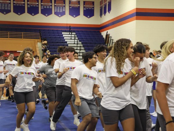 Seniors run in to the gym to kick off the assembly