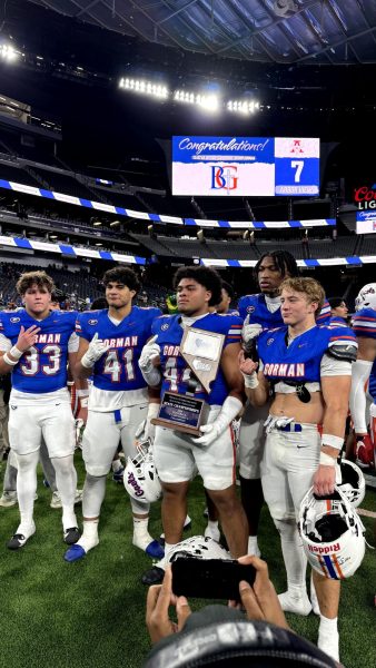 Ryan Baalbaky '25, Prince Williams '26, Sione Motuapuaka '25, Jett Washington '25, and Aksel Ferry '25 posing with the Nevada 5A-I State trophy. 