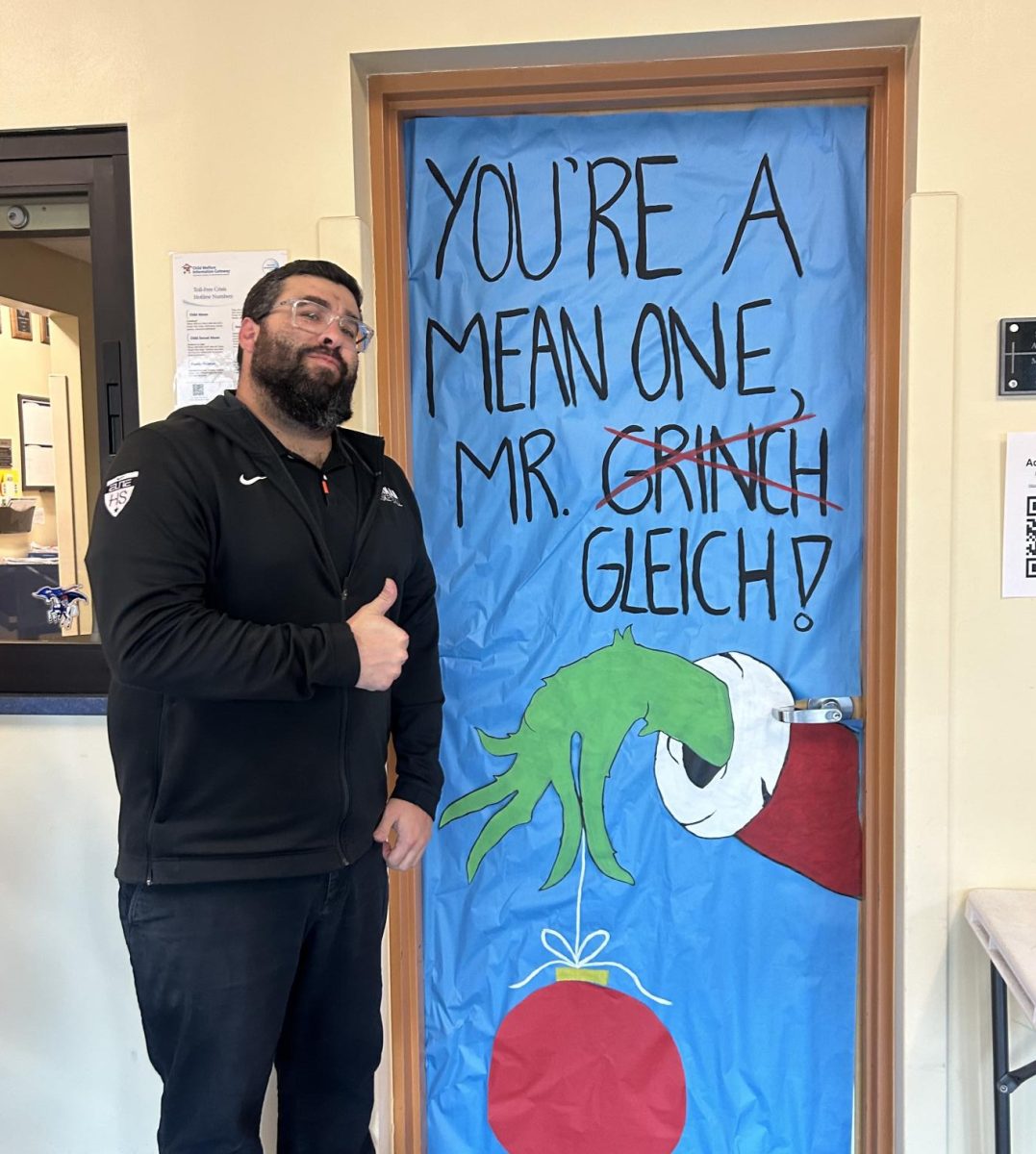 Mr. Gleich in front of the door or his office. 