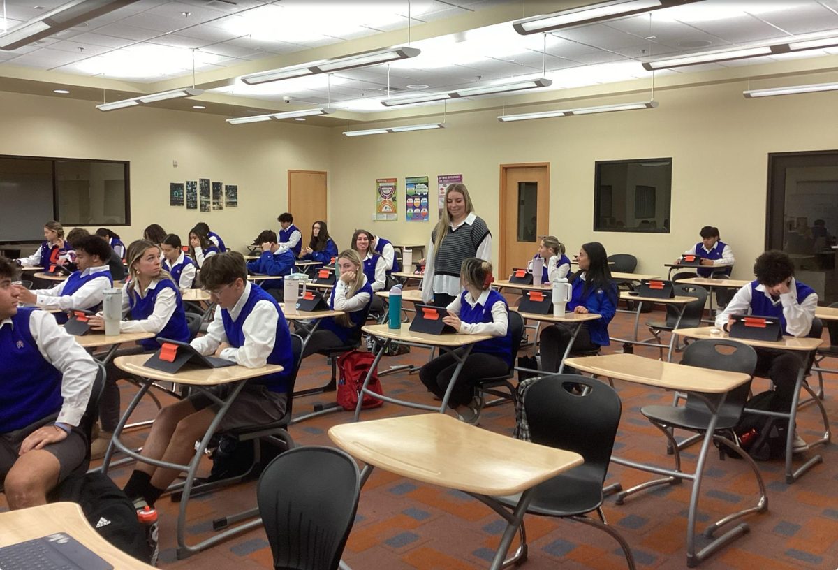 Ms. Wilcox helping students in her study hall on a mass day. 