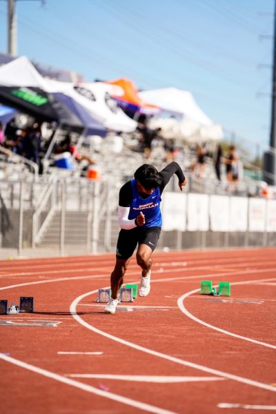 Sid getting off the blocks in a track meet. He is warming up and practicing for the 200 meter sprint.