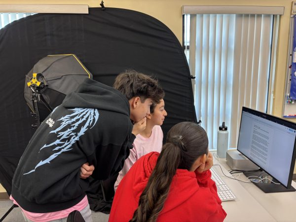 Valerie Vazquez '26, Niko Rodriguez '28, and Anna Barragan '27 working in class. 