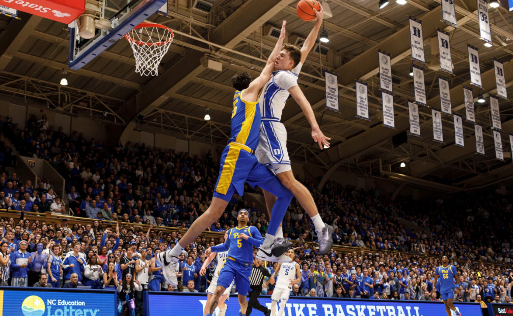 Cooper Flagg dunking on Guillermo Diaz Graham.