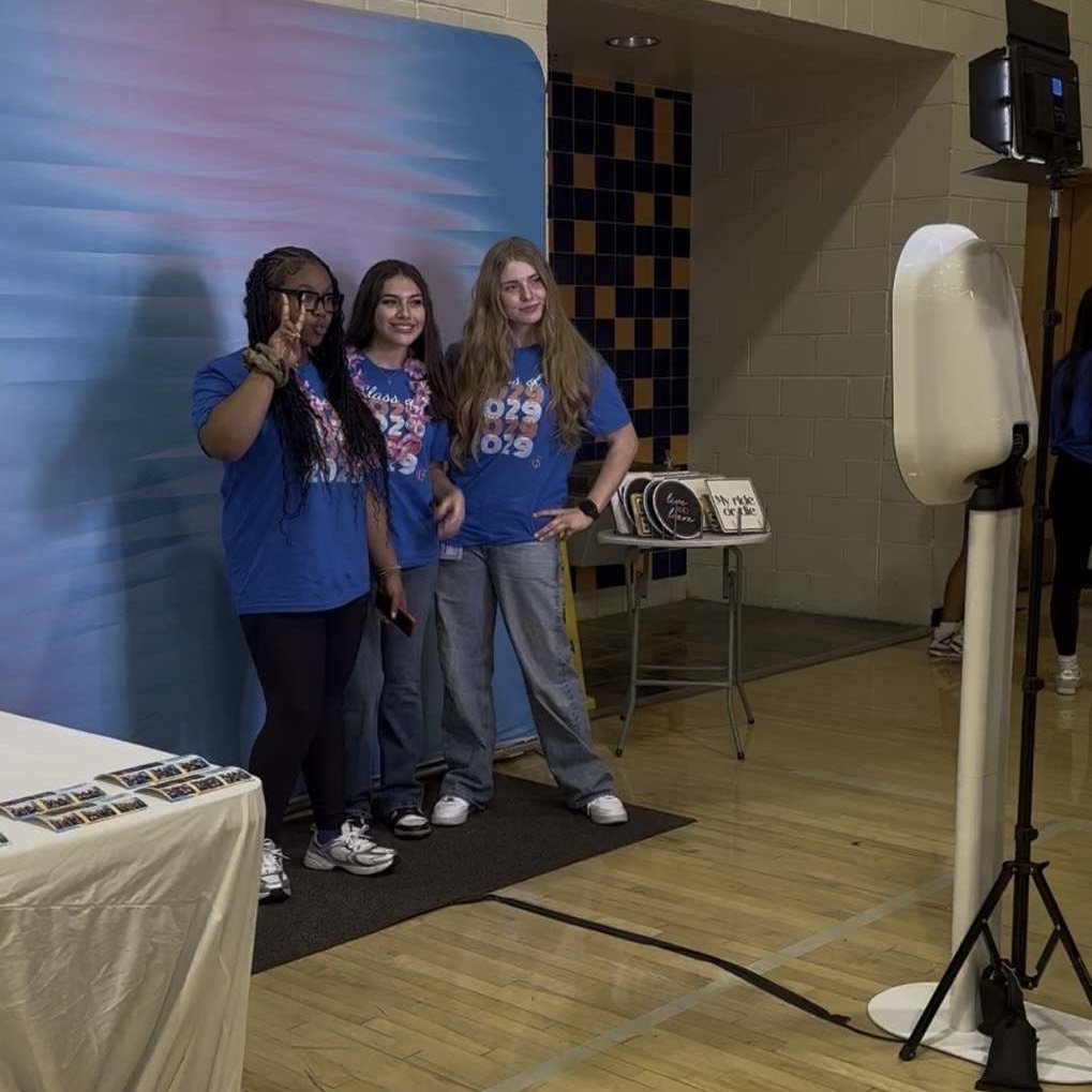 Friends come together to take pictures at the Photo Booth during the annual Aloha dance. 