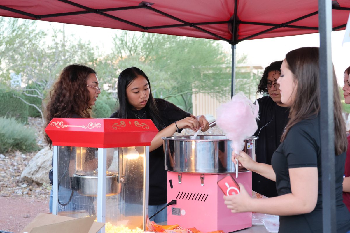 Core Team leaders Lulu Manuel '26 and Kyrene Sideco '26 making cotton candy and popcorn at the Upper Room Kick off Barbecue. 