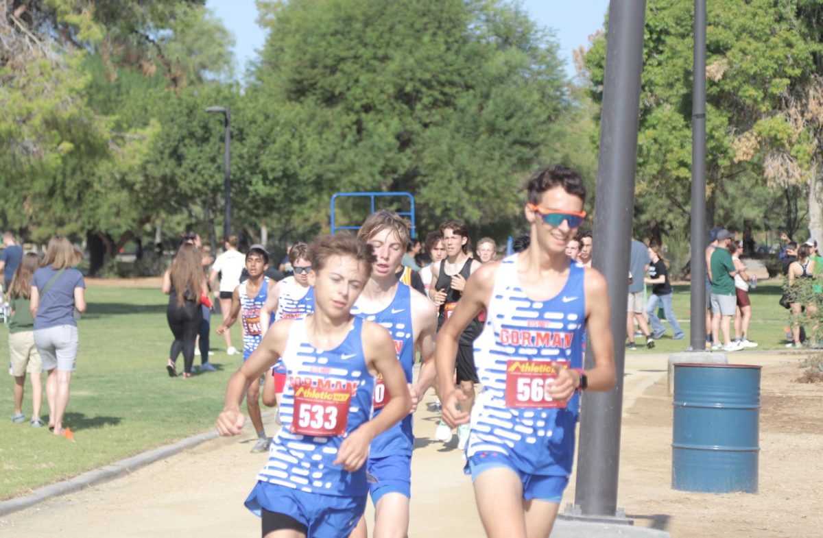 Micheal Toms ‘27, (right) George Baggott ‘27, (left) and Hayes Janson ‘27 (back) running in action at a cross country meet.