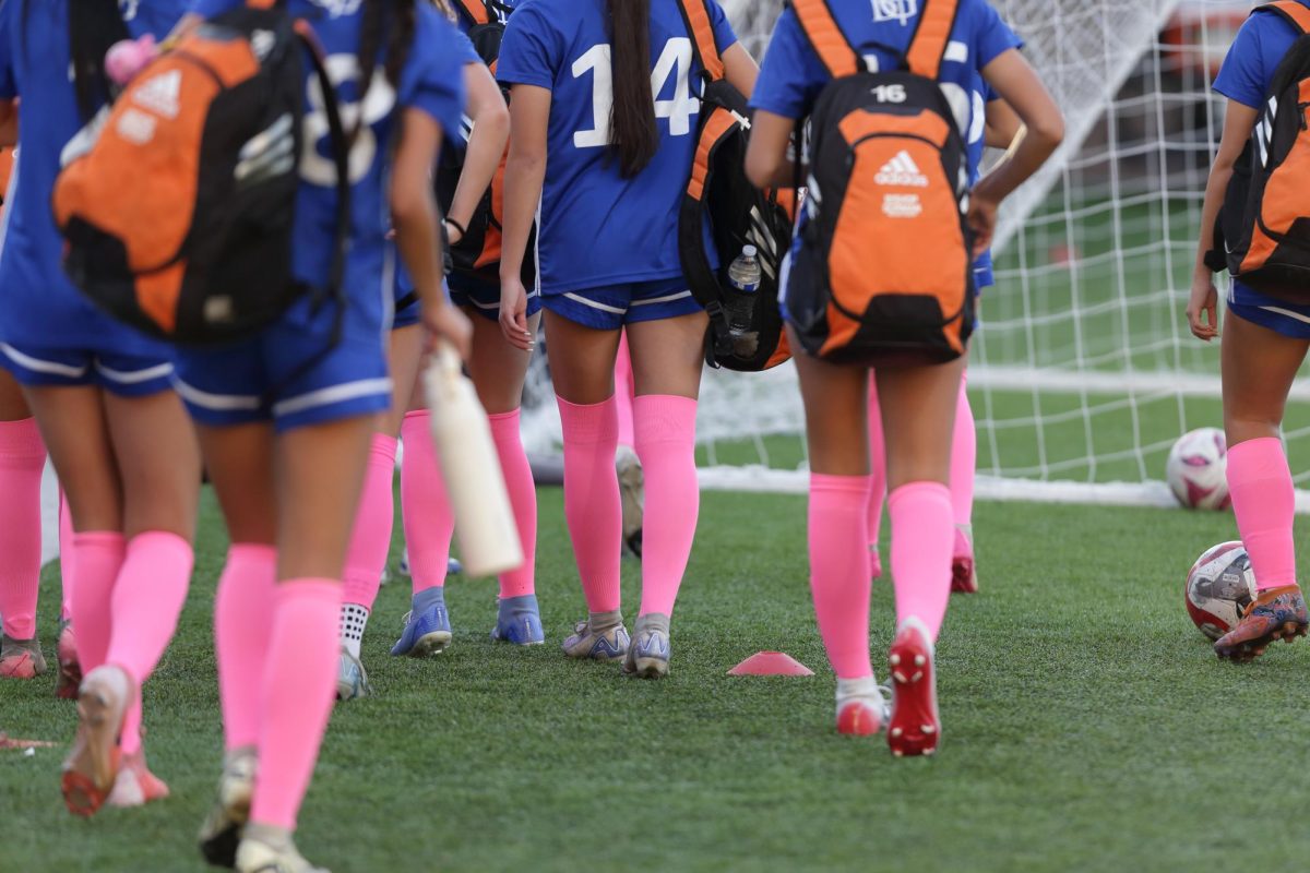 Women's soccer wore pink socks for the pink out game.