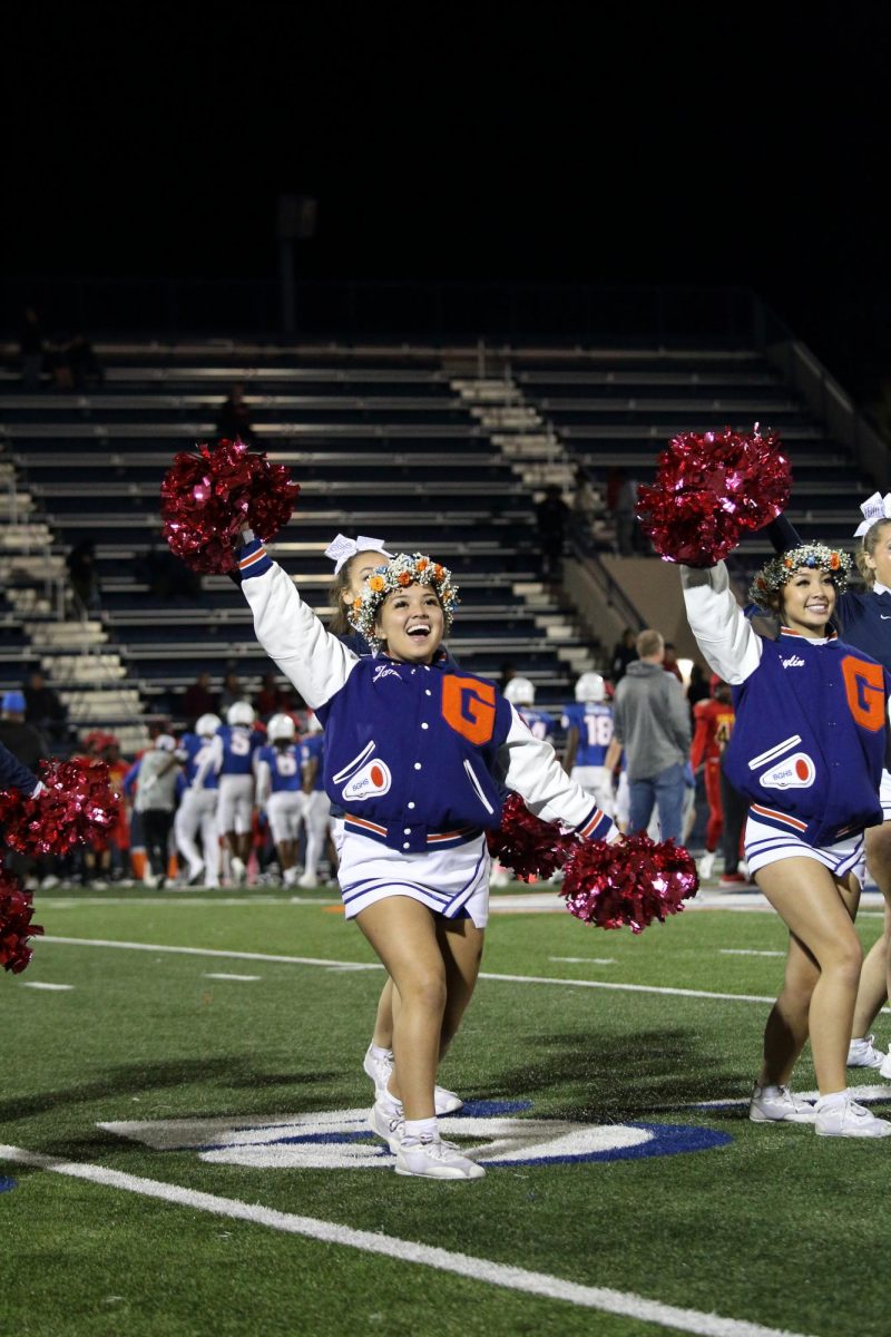 Senior Jamen Ganzon gathered with fellow cheerleaders performing during halftime.