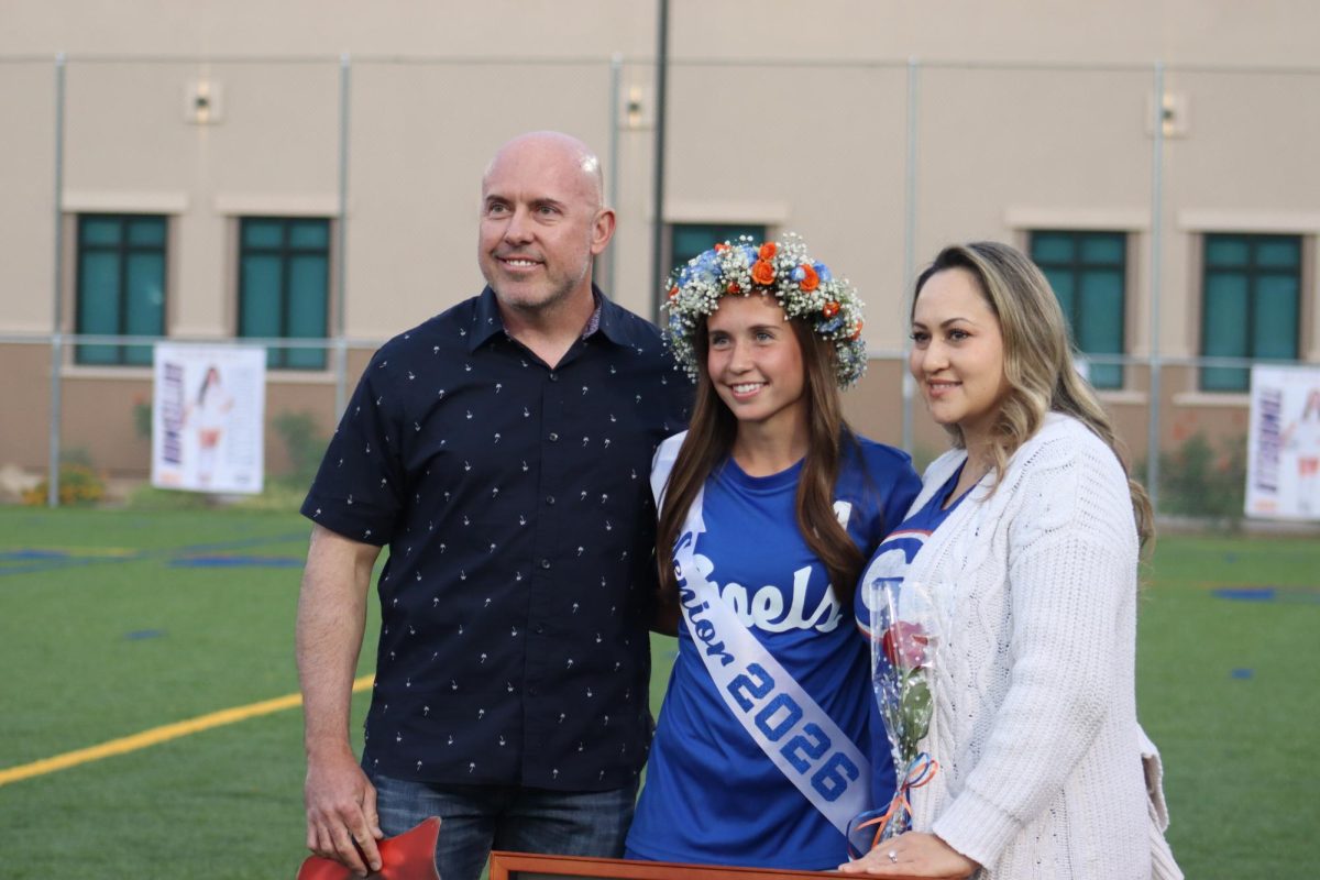 Gianna Tomasello '26 and her parents at senior night. 