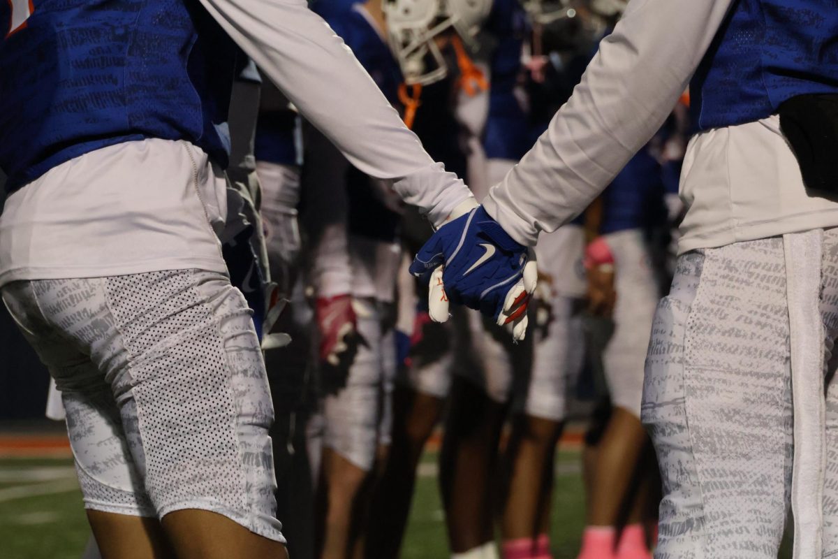 Football players join hand in hand on their senior night