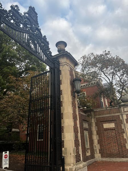 A picture of a gate leading towards the Harvard campus.