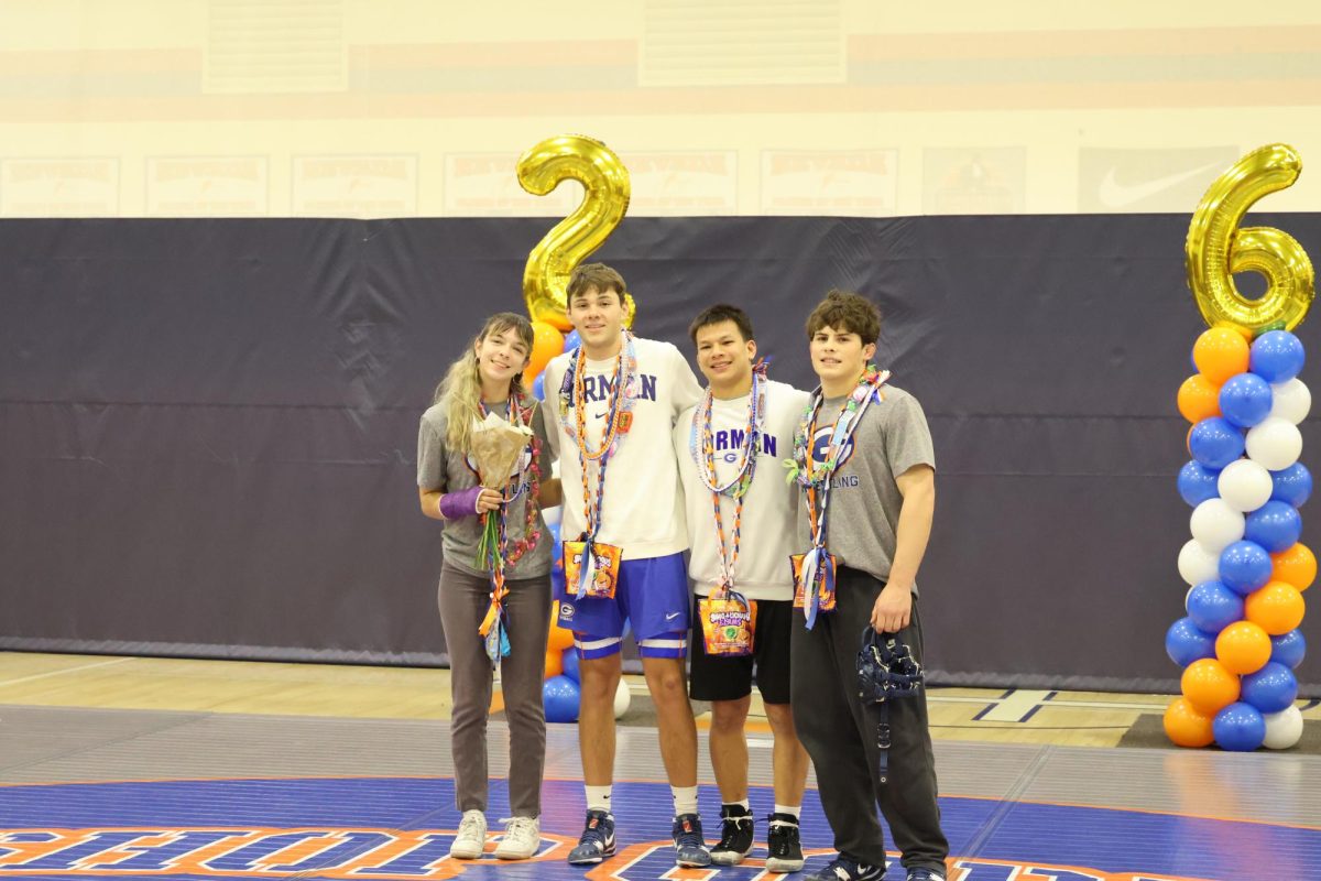 Wrestlers posed together for their senior night.