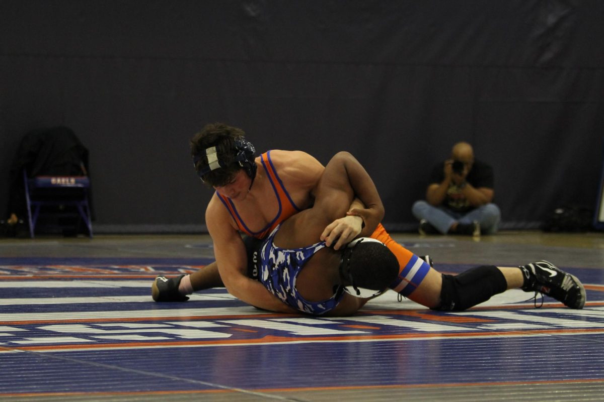 Maddox Frerking '26 going to half nelson his opponent.