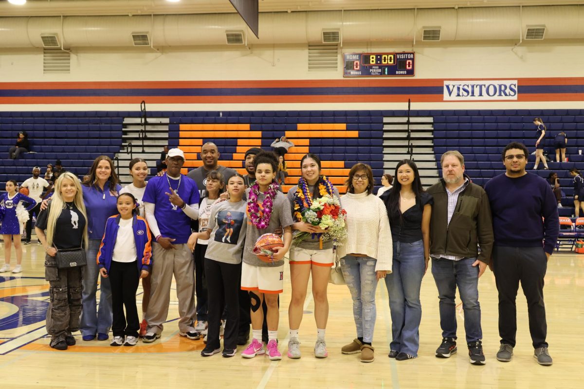 Lizzy Spaight '26 and Mackenzie Motzny '26 with their families on senior night and final home game of their high school basketball careers. 