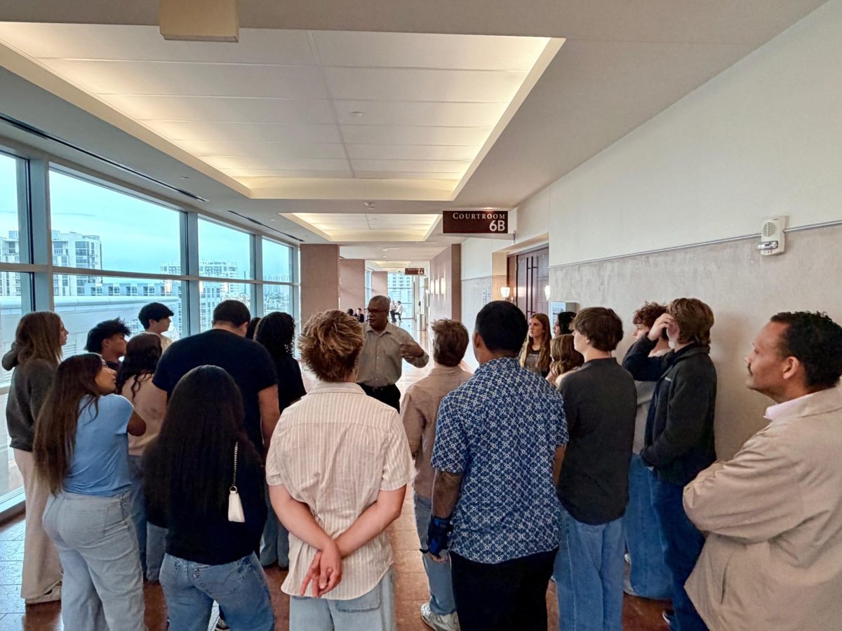 Students receiving instructions from Mr. Nixon before they enter the courtroom at the Regional Justice Center on March 31.