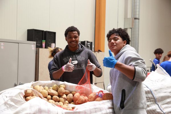 Sophomores Tayaun Lawrence and Pesi Silva spend the day sacking potatoes at Three Square. 